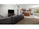 Open-concept living space with a comfortable leather couch, and a view of the kitchen at 6306 Pecan Crse, Ocala, FL 34472