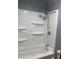 Clean bathroom featuring a white bathtub and shower combo with multiple shelves for storage at 6498 Se 167Th Ct, Ocklawaha, FL 32179