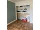 Empty walk-in closet featuring built-in shelving, tile flooring, and plenty of storage space at 6498 Se 167Th Ct, Ocklawaha, FL 32179