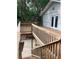 Multi-level wooden deck featuring views of greenery, offering outdoor living and relaxation at 6498 Se 167Th Ct, Ocklawaha, FL 32179