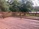 Outdoor deck overlooks lush greenery, providing a peaceful outdoor space for relaxation and enjoyment at 6498 Se 167Th Ct, Ocklawaha, FL 32179