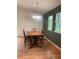 Charming dining room featuring a chandelier, a four chair table and two large windows at 6498 Se 167Th Ct, Ocklawaha, FL 32179