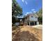 Unique home featuring a covered porch entry with wooden stairs and a stilt foundation at 6498 Se 167Th Ct, Ocklawaha, FL 32179