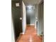 Hallway with hardwood floors, leading to a bright space, and freshly painted walls at 6498 Se 167Th Ct, Ocklawaha, FL 32179