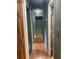 Hallway with wood floors featuring multiple doors and dark colored walls at 6498 Se 167Th Ct, Ocklawaha, FL 32179