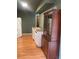 View of a kitchen featuring a refrigerator, cabinets, a door and an antique cabinet at 6498 Se 167Th Ct, Ocklawaha, FL 32179