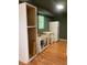 View of the kitchen that features a refrigerator, a window, and base cabinets at 6498 Se 167Th Ct, Ocklawaha, FL 32179