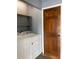 Functional laundry room featuring a modern washer and dryer with door and shelf at 6498 Se 167Th Ct, Ocklawaha, FL 32179