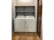 Laundry room featuring white washer and dryer, wooden shelving, and neutral tile flooring at 6498 Se 167Th Ct, Ocklawaha, FL 32179