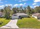 Inviting single-story home with a spacious lawn, long driveway, and a well-maintained facade at 6730 Cherry Rd, Ocala, FL 34472