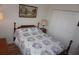 Bedroom features wood floors, quilt bedspread, and closet at 6836 Sw 112Th St, Ocala, FL 34476