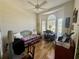 Bright bedroom with wood floors, fan, daybed, and large windows at 6836 Sw 112Th St, Ocala, FL 34476