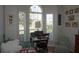 Bright bedroom with wood floors, fan, daybed, and large windows at 6836 Sw 112Th St, Ocala, FL 34476