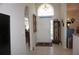 Grand foyer featuring tile flooring, a high arched window, and elegant furnishings at 6836 Sw 112Th St, Ocala, FL 34476