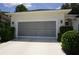Attached garage with screened-in door and well-maintained landscaping at 6836 Sw 112Th St, Ocala, FL 34476