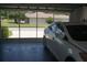 View from the garage with screen to the driveway, plus car at 6836 Sw 112Th St, Ocala, FL 34476