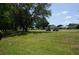 Scenic golf course view with lush greenery, mature trees, and golf carts in the distance at 6836 Sw 112Th St, Ocala, FL 34476