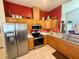 Bright kitchen features stainless steel appliances, wood cabinets, and tiled floors at 6836 Sw 112Th St, Ocala, FL 34476