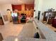 Traditional eat-in kitchen with stainless steel appliances, wooden cabinets, and tile flooring at 6836 Sw 112Th St, Ocala, FL 34476