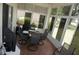 Enclosed lanai with tile flooring, a round table with seating for four, and scenic outdoor views at 6836 Sw 112Th St, Ocala, FL 34476