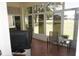 Screened lanai with tile floor, comfortable seating, TV, and peaceful views of the backyard at 6836 Sw 112Th St, Ocala, FL 34476