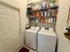 Efficient laundry room with modern washer and dryer set, along with ample shelving at 6836 Sw 112Th St, Ocala, FL 34476