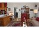 Open-concept living room with hardwood floors, traditional furnishings, and access to the kitchen at 6836 Sw 112Th St, Ocala, FL 34476