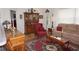 Cozy living room featuring a traditional hutch, red wingback chair, and a patterned area rug at 6836 Sw 112Th St, Ocala, FL 34476