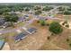 Birds-eye view capturing homes, each with a unique roof design and exterior paint, situated along a quiet street in a suburban neighborhood at 69 Juniper Trail Loop, Ocala, FL 34480
