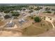 Aerial view of single-Gathering homes nestled among lush greenery in a quiet residential neighborhood at 69 Juniper Trail Loop, Ocala, FL 34480