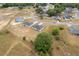 A high angle shot capturing multiple single-Gathering homes, each with its own yard, and a paved road winding through the community at 69 Juniper Trail Loop, Ocala, FL 34480