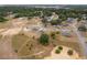 Expansive aerial view of a neighborhood with well-maintained homes and surrounding greenery, showcasing a peaceful residential setting at 69 Juniper Trail Loop, Ocala, FL 34480