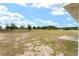 Expansive backyard with a concrete patio, offering ample space for outdoor activities and relaxation at 69 Juniper Trail Loop, Ocala, FL 34480