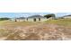 View of backyard and rear exterior featuring a sliding glass door and windows at 69 Juniper Trail Loop, Ocala, FL 34480