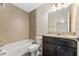 Bathroom features a tiled shower-tub combination and granite vanity at 69 Juniper Trail Loop, Ocala, FL 34480