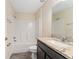 Bright bathroom features a granite countertop, framed mirror, shower-tub combination, and modern fixtures at 69 Juniper Trail Loop, Ocala, FL 34480
