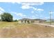 Well-maintained single-story home featuring a spacious front yard and extended driveway at 69 Juniper Trail Loop, Ocala, FL 34480