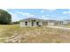 Charming single-story home with a two-car garage, grassy front yard, and a welcoming entrance at 69 Juniper Trail Loop, Ocala, FL 34480