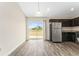 Bright kitchen features stainless steel appliances, dark cabinets, and sliding doors at 69 Juniper Trail Loop, Ocala, FL 34480