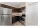 The kitchen features dark wood cabinets and stainless steel appliances at 69 Juniper Trail Loop, Ocala, FL 34480