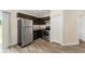 Kitchen has stainless fridge and range, as well as dark cabinets and granite counters at 69 Juniper Trail Loop, Ocala, FL 34480