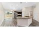 Open kitchen with granite counters, stainless appliances, and sliding glass door at 69 Juniper Trail Loop, Ocala, FL 34480