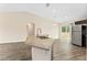 Kitchen island features granite countertop with stainless steel sink and pendant lighting at 69 Juniper Trail Loop, Ocala, FL 34480