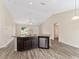 Kitchen with granite countertops and breakfast bar overlooking the living room at 69 Juniper Trail Loop, Ocala, FL 34480
