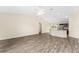 Spacious living room with light gray flooring, a ceiling fan, and plenty of natural light at 69 Juniper Trail Loop, Ocala, FL 34480