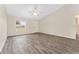 Spacious living room with light gray flooring, a ceiling fan, and plenty of natural light at 69 Juniper Trail Loop, Ocala, FL 34480