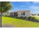 Landscaped backyard featuring a covered patio and well-maintained lawn at 7706 Sw 89Th Ct, Ocala, FL 34481