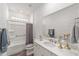 Well-lit bathroom with a shower-tub combo and granite vanity at 7706 Sw 89Th Ct, Ocala, FL 34481