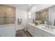 Bright bathroom featuring double vanity, quartz countertops, and tiled walk-in shower at 7706 Sw 89Th Ct, Ocala, FL 34481