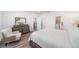 Bright bedroom with a dresser, comfortable chair, and an ensuite bathroom at 7706 Sw 89Th Ct, Ocala, FL 34481